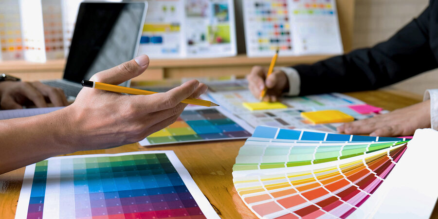 Graphic Designers Choose Colors From The Color Bands Samples For