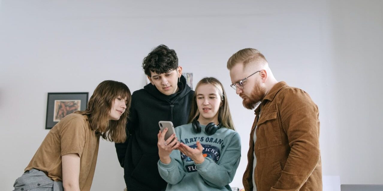 pexels-ivan-samkov-7213646 Family Looking at smart phone