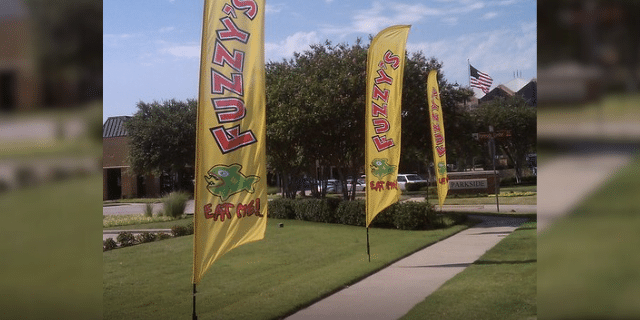 promotional flags for Fuzzy's pizza place