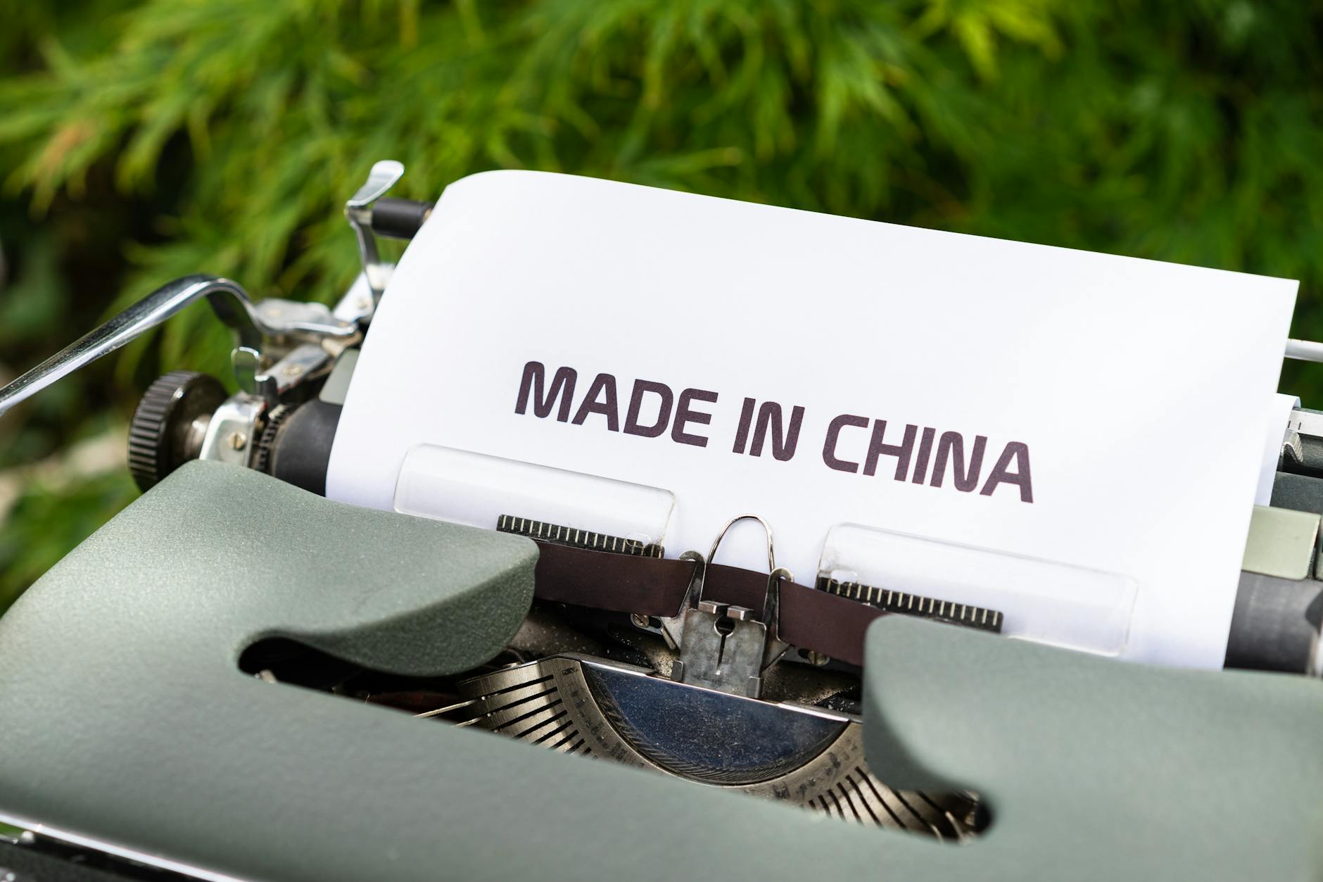 Image of old printer with paper spelling "made in China" Catdi Houston printing shop