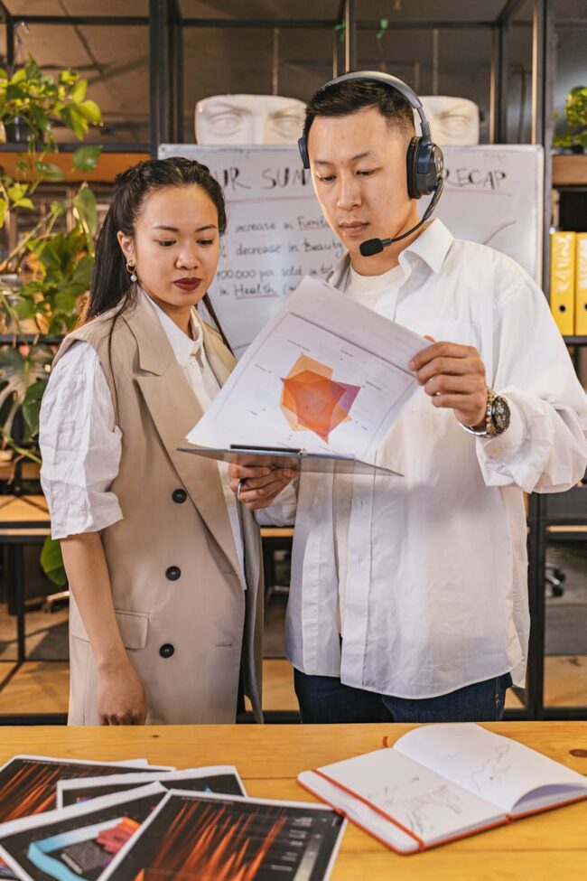 Event host reviewing presentation material Catdi Houston printing professionals