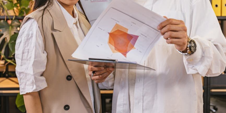 1742125343183×548232477511623400-feature Event host reviewing presentation material Catdi Houston printing professionals