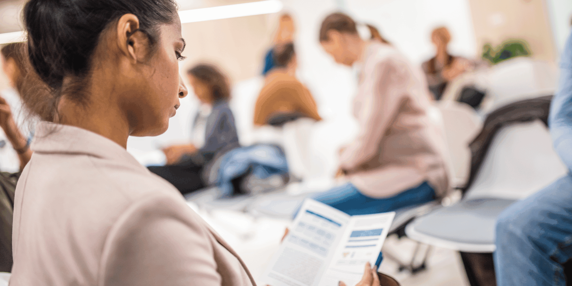 Woman browsing through flyer – Catdi Printing woman at business conference in Houston reading flyer -Catdi, Houston printing experts