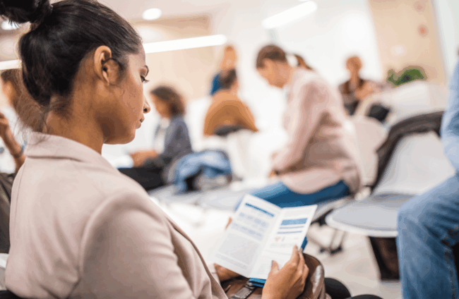 woman at business conference in Houston reading flyer -Catdi, Houston printing experts
