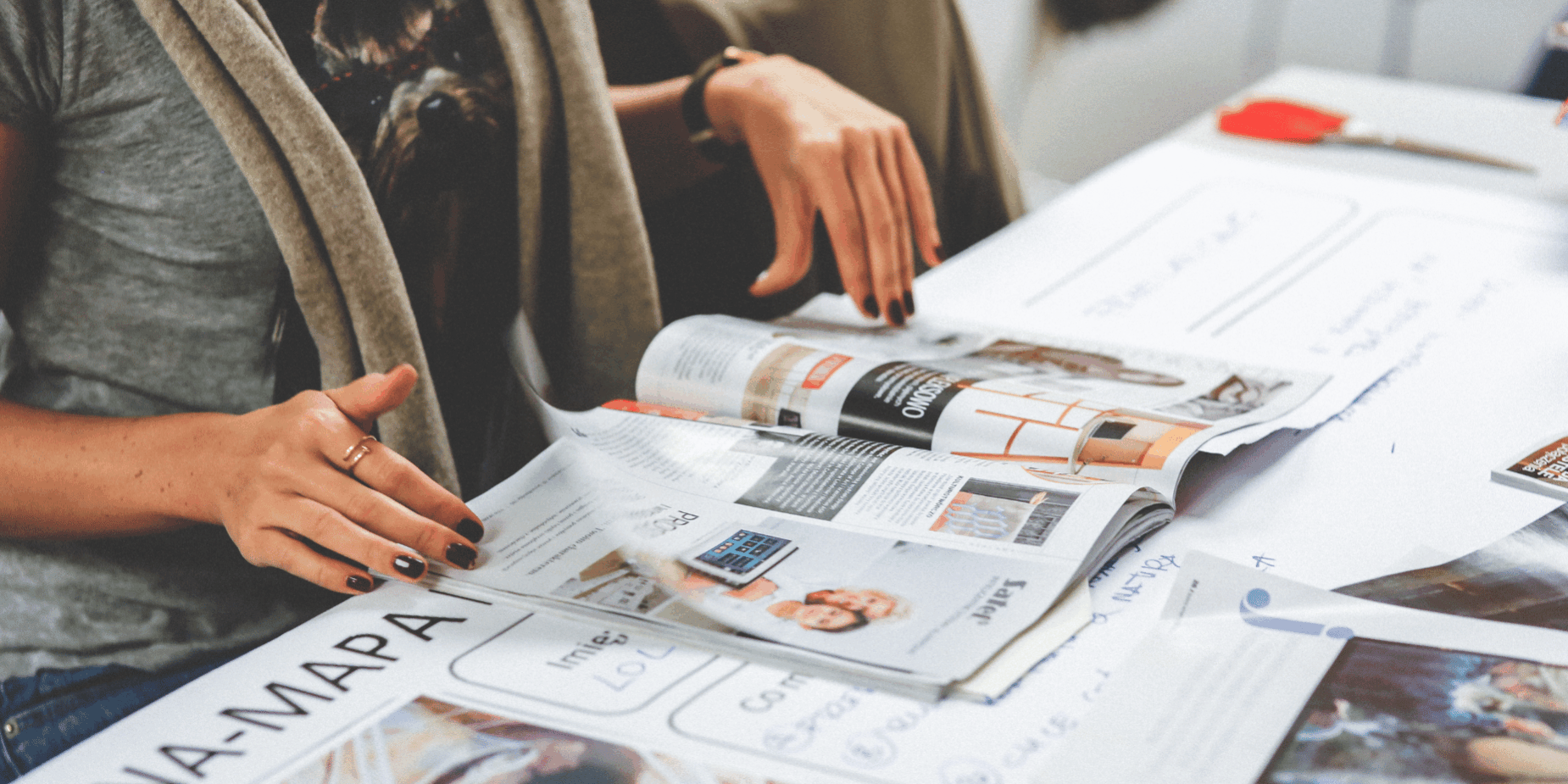 woman reviewing printing collateral on table at Houston central office - Catdi Houston printing packages